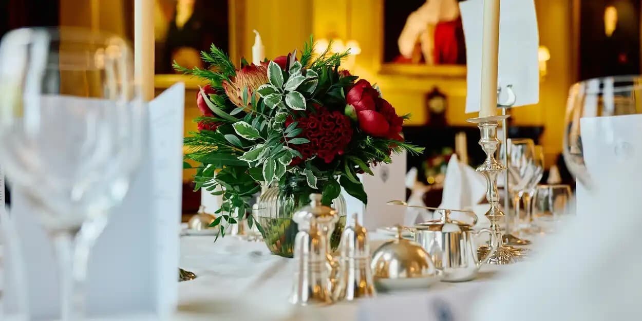 White table cloth with formal dinner setting.